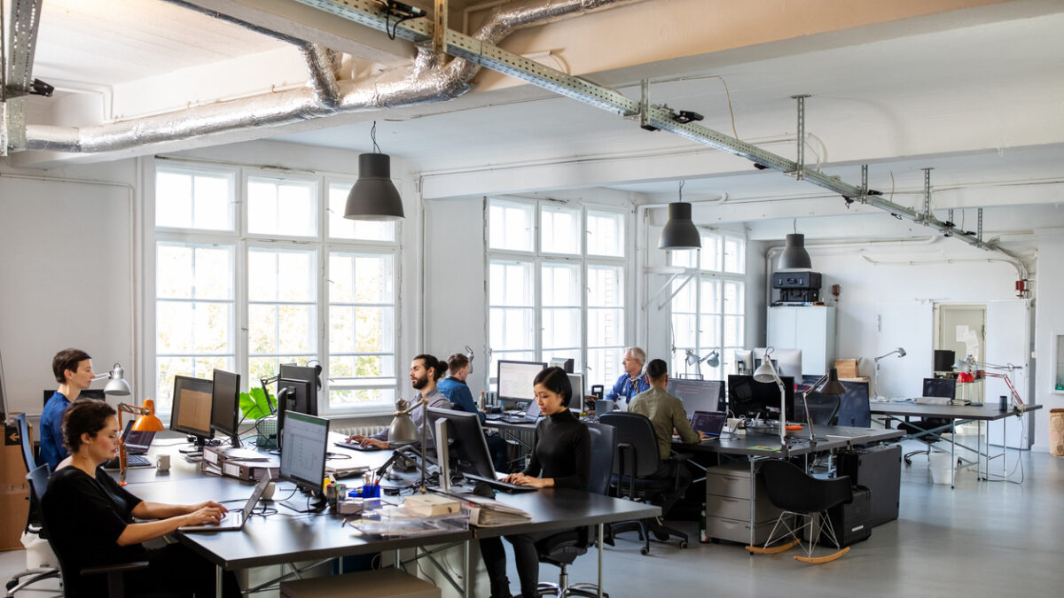 Casually dressed workers in a busy open plan office. Business people working at a modern office.