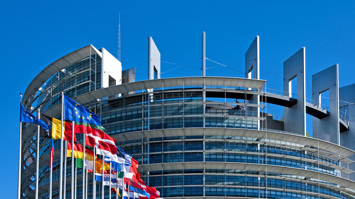 The European Parliament building in Strasbourg, France with flags waving calmly celebrating peace of the Europe. July 12, 2020.