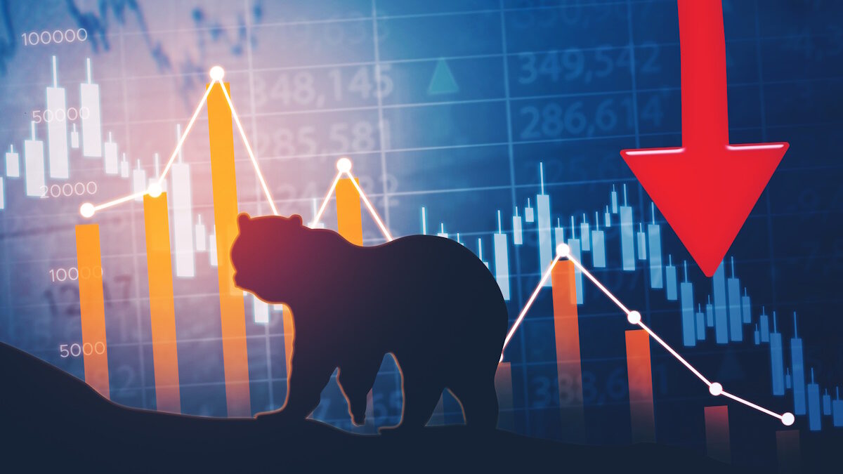 Silhouette of bear walking with declining finance chart and stock market background