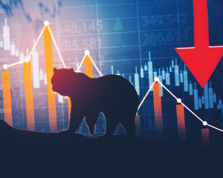 Silhouette of bear walking with declining finance chart and stock market background