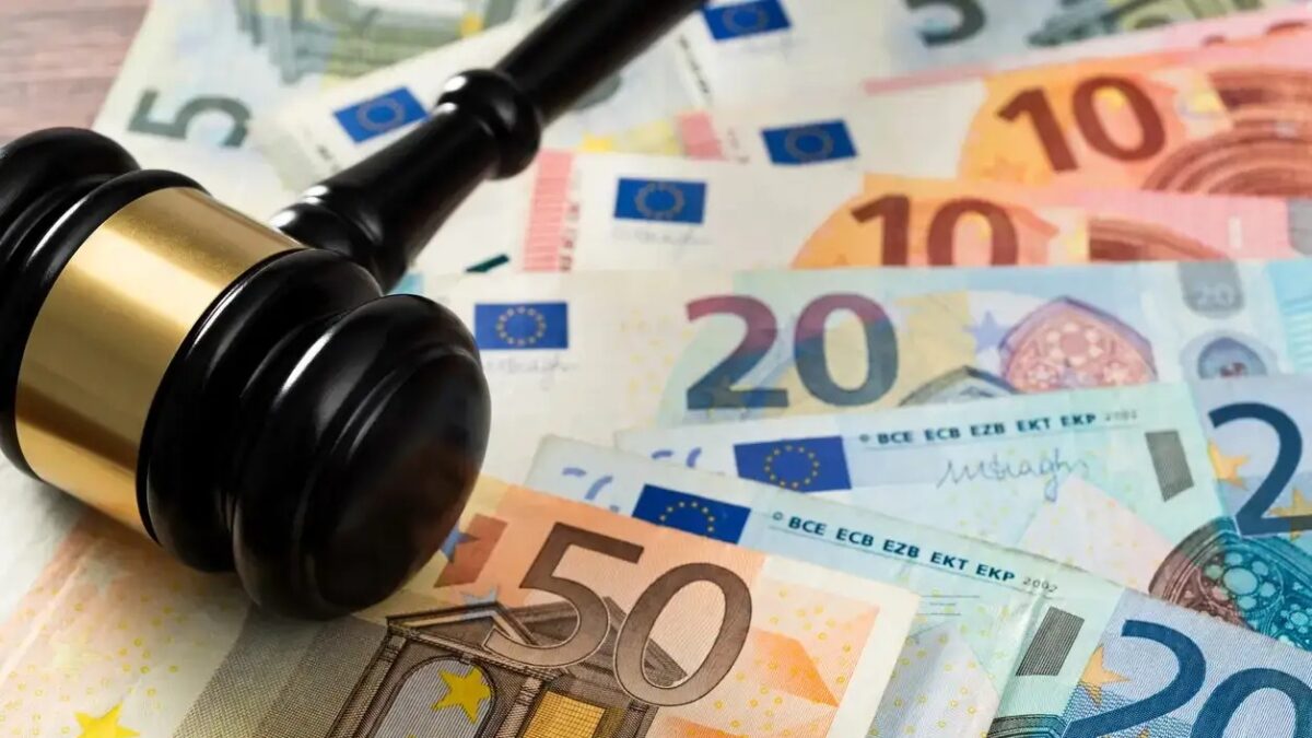Gavel and stack European Union currency on the table.