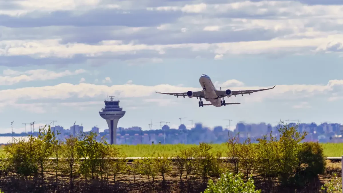 Great plane taking off and taking height next to the control tower of the airport, Madrid, Spain