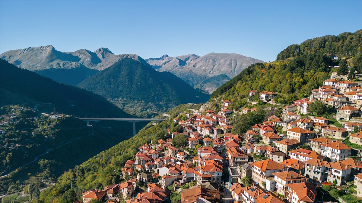 Aerial view of town settled on mountain slopes. Traditional architecture and culture of living. Photo made with drone