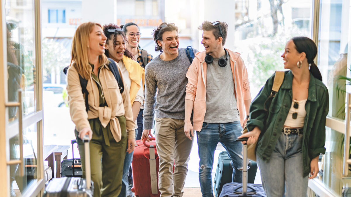 Group of university college tourist walking inside the hotel with suitcases -Young happy students enjoying summer holiday-Tourism Vacation and Lifestyle concept with people-Youth culture-Spring time foitites - students