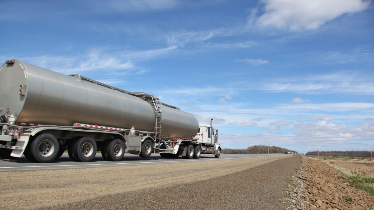 Truck tanking delivering its load. Selective focus on front of truck. Rear of trailer out of focus. Motion blur of tires and perhaps some on rear of truck.For similar pictures go to