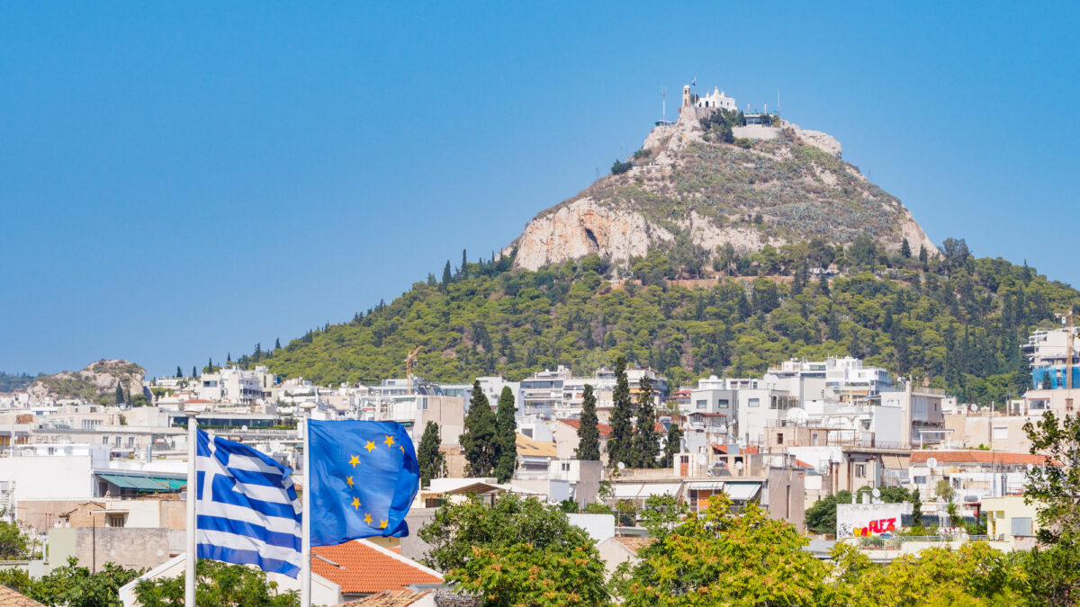 Greek and EU flag in in front of Likabetus Hill, Athens, Greece