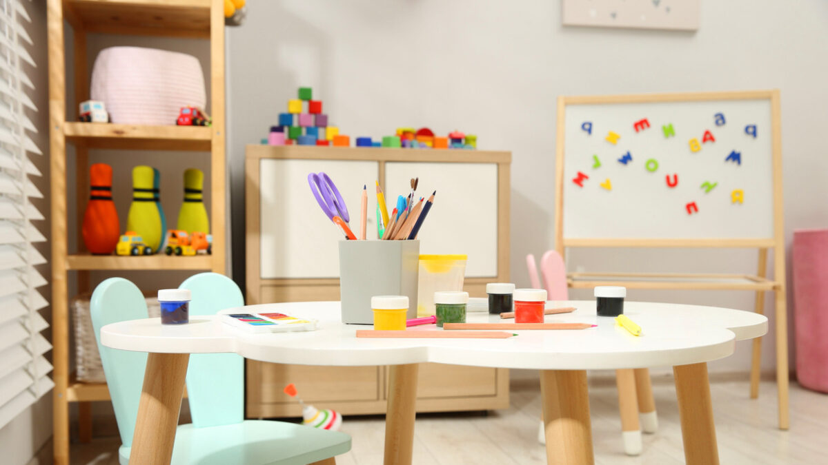 Table with paints and other stationery in child's room