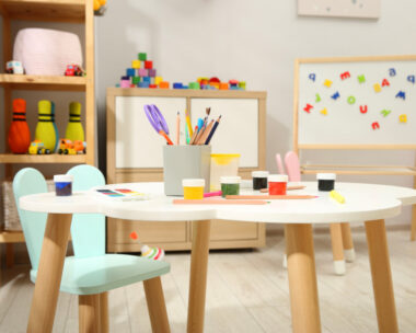 Table with paints and other stationery in child's room