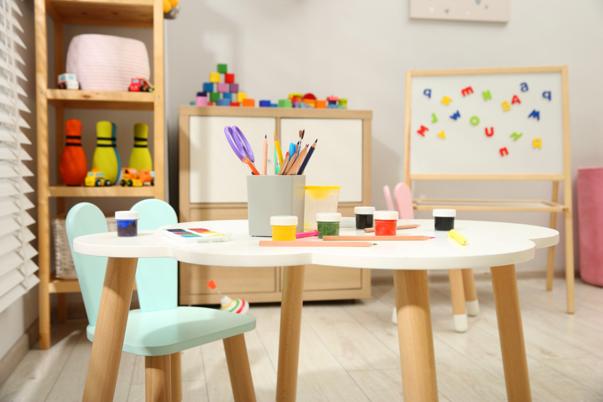 Table with paints and other stationery in child's room