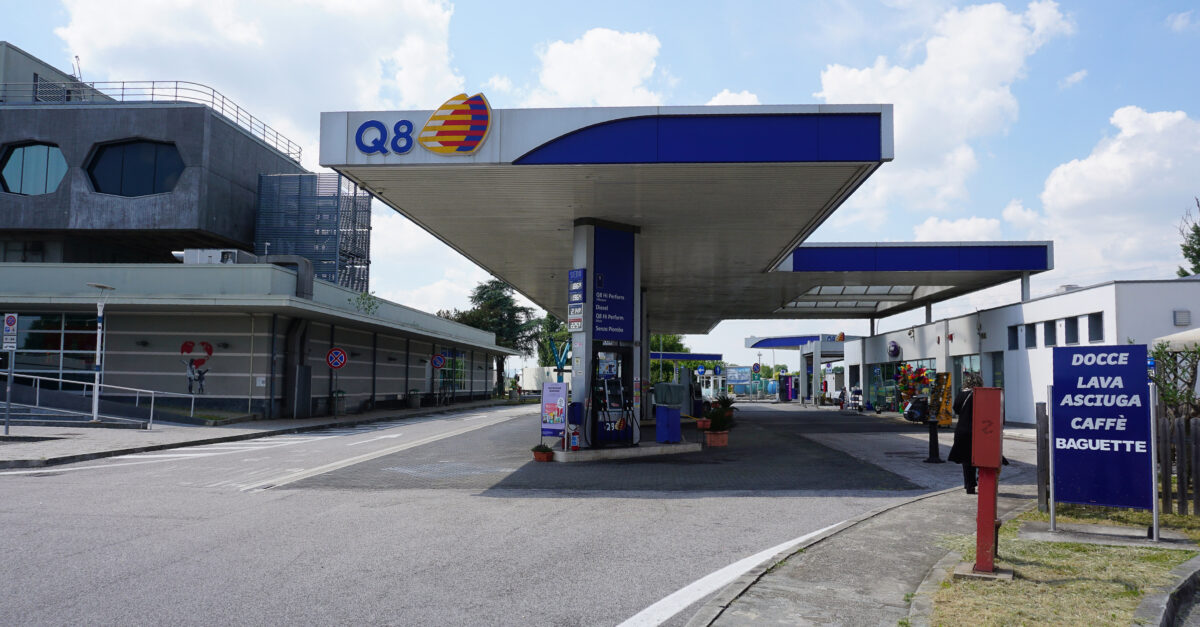OSTUNI, ITALY - May 11, 2025: The banner of Q8 gas station with prices of gasoline and diesel fuel displayed on highway