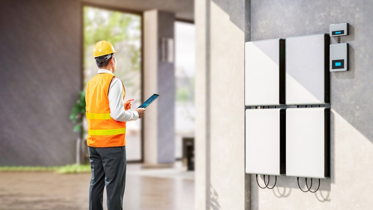 Asian engineer or technician with battery energy storage system for residential used