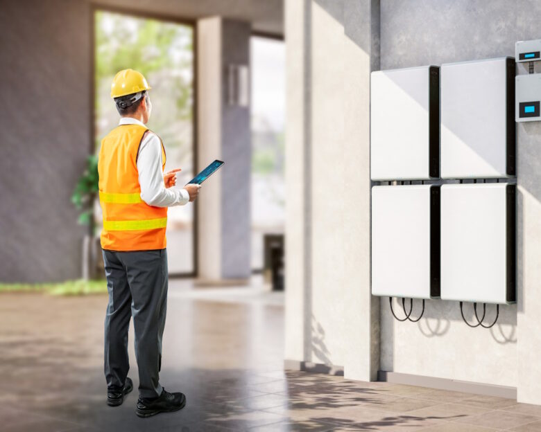 Asian engineer or technician with battery energy storage system for residential used
