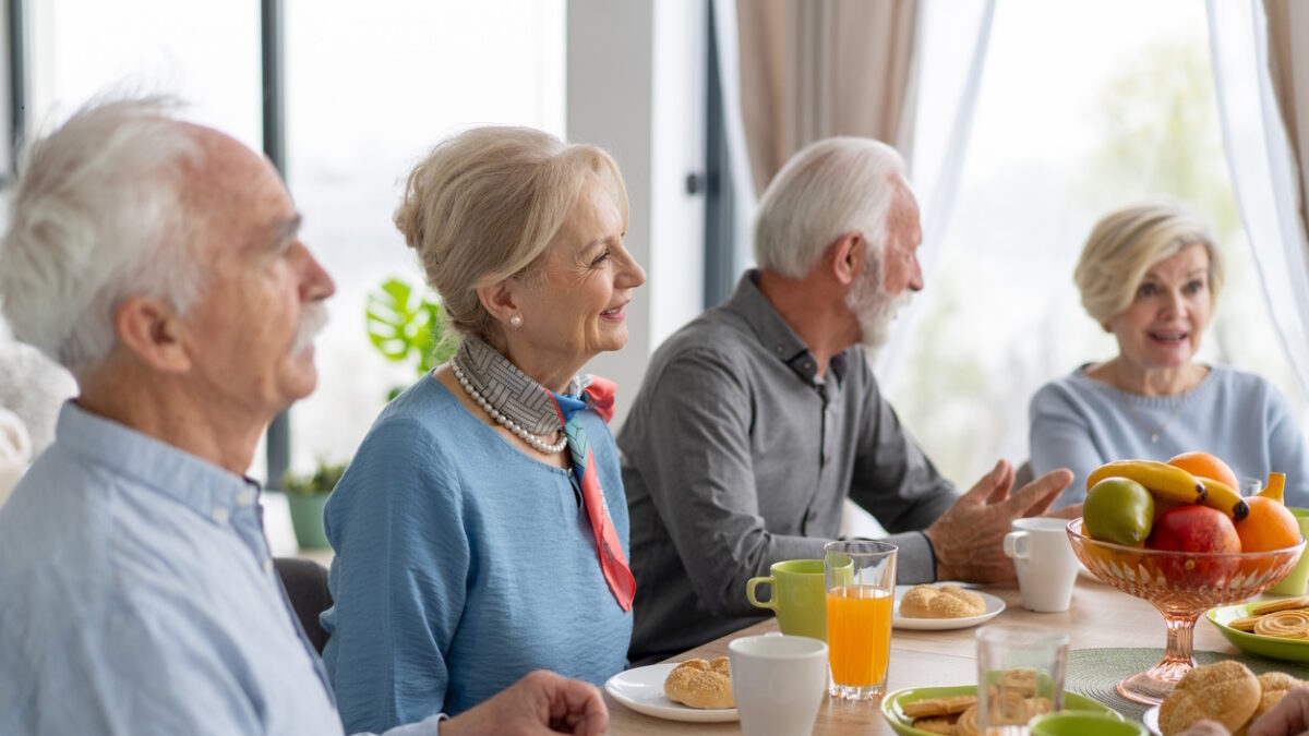 Seniors enjoy refreshing drinks and good company over delightful conversations, exemplifying warmth and human connection.
