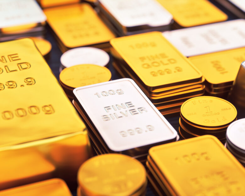 A collection of gold and silver ingots and coins, close up.