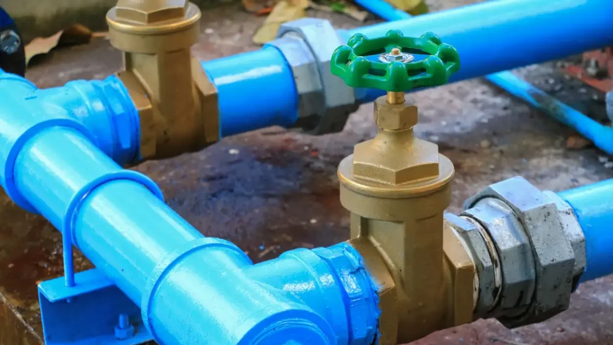 water valve plumbing joint steel tap pipe with green knob close up