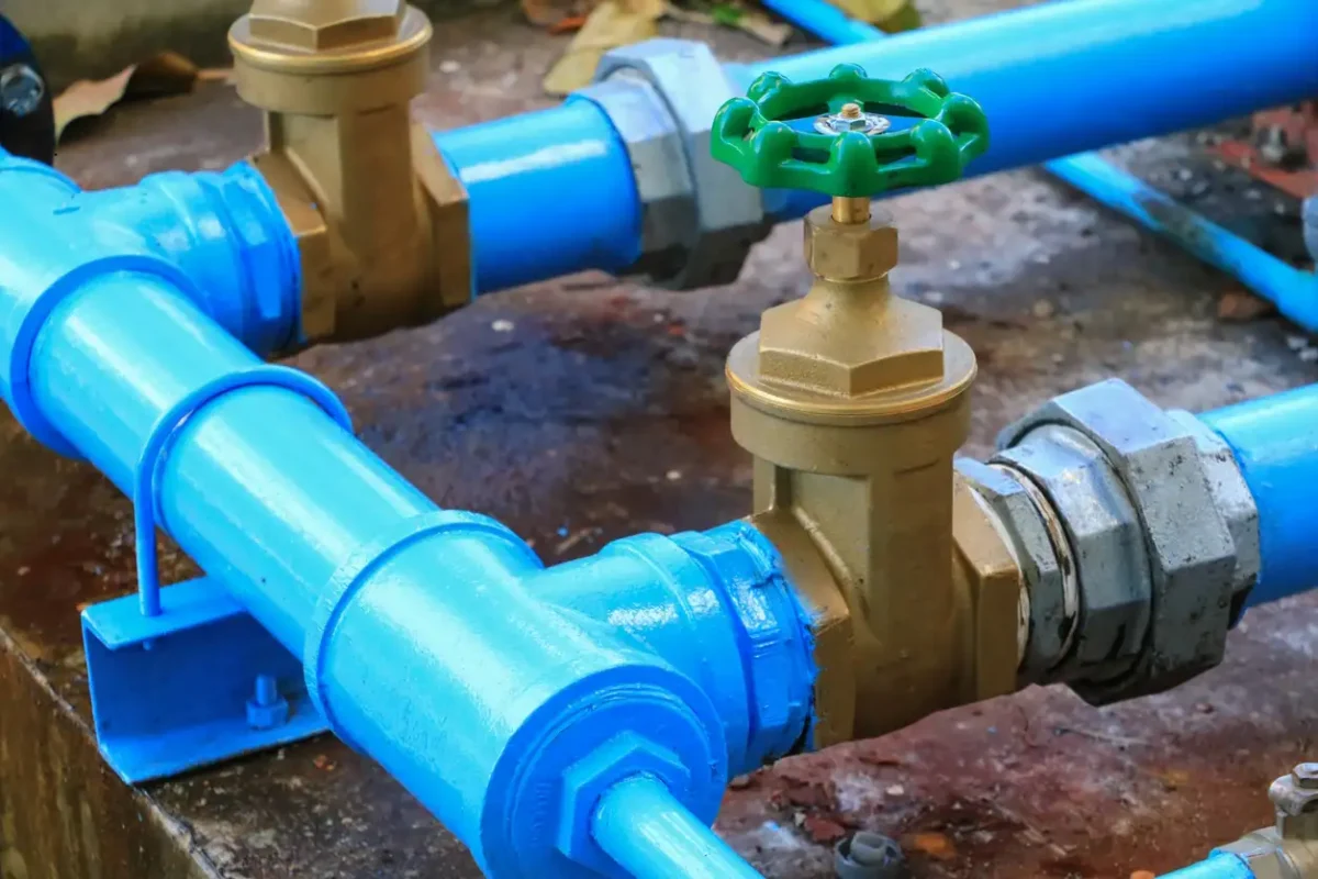 water valve plumbing joint steel tap pipe with green knob close up