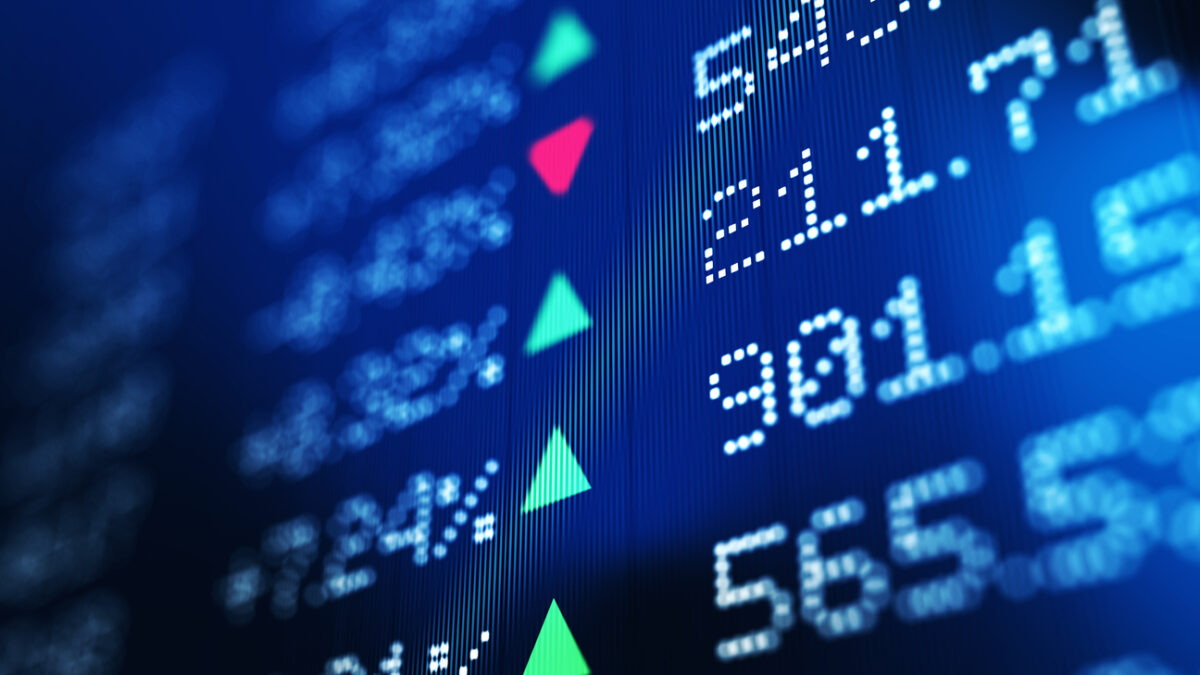 Financial data analysis graph showing stock market trends on a trading board. Horizontal composition with copy space and selective focus.