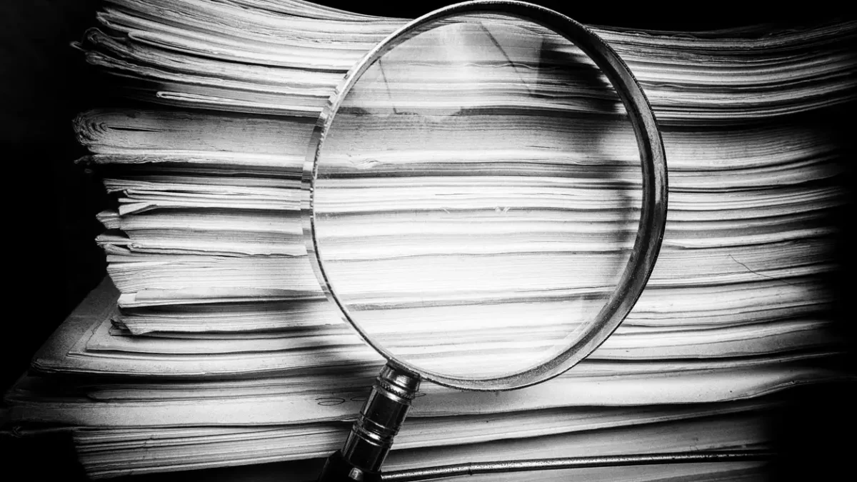 Handheld Magnify glass inspects paper documents