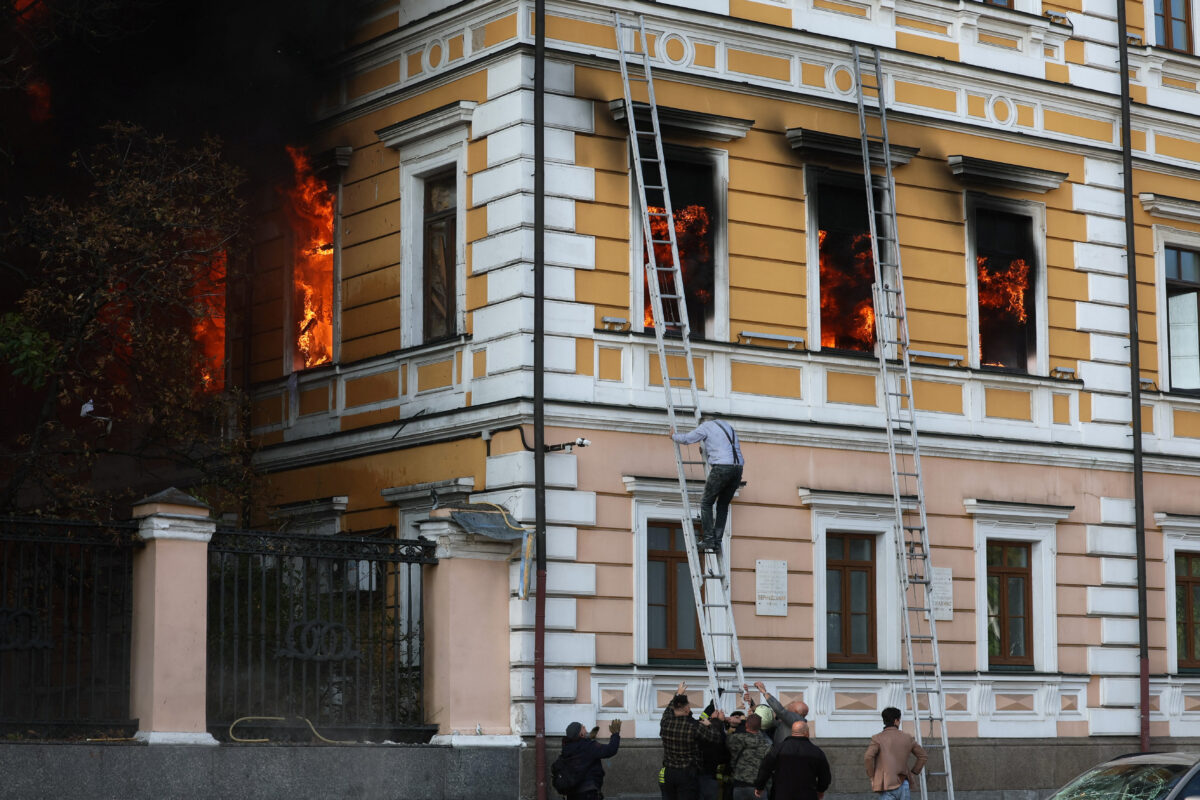 People help a man to evacuate an administrative building hit by a Russian jet-powered drone strike, amid Russia's attack on Ukraine, in Kyiv, Ukraine, September 28, 2026. REUTERS