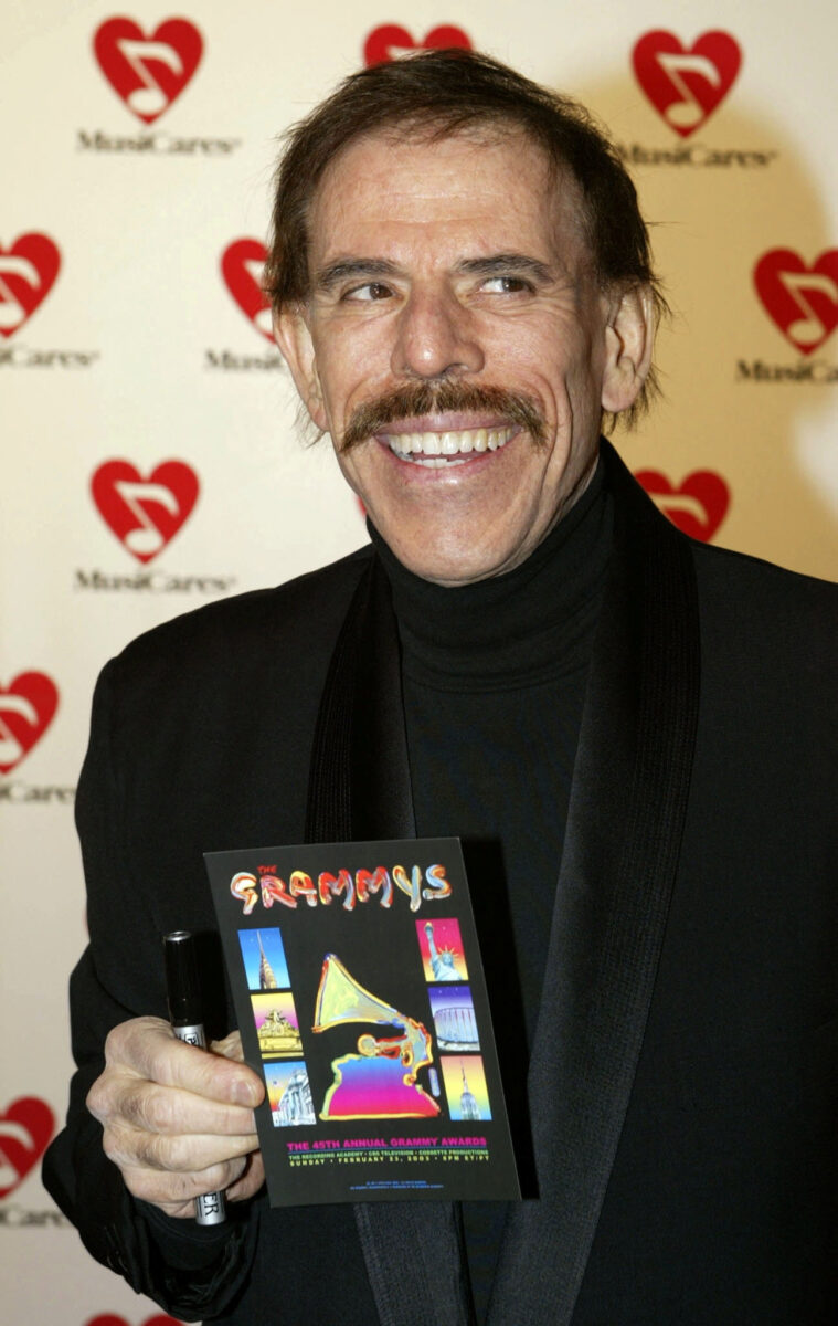 FILE PHOTO: Artist Peter Max arrives as a guest for the Academy of Recording Arts and Sciences Musicares Person of the Year tribute dinner in New York, U.S., February 21, 2003. REUTERS/Fred Prouser/File Photo