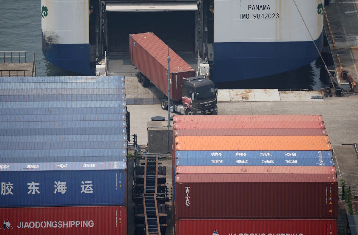 FILE PHOTO: A truck unloads a shipping container at Pyeongtaek port in Pyeongtaek, South Korea, July 8, 2025.