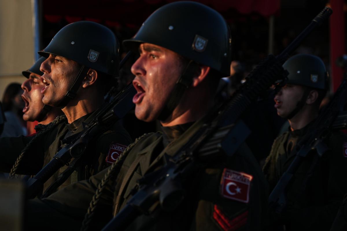 Turkish soldiers shout slogans during a military parade marking the 52nd anniversary of the 1974 Turkish invasion in the Turkish occupied area, in the divided capital of Nicosia, Cyprus, Monday, July 20, 2026.