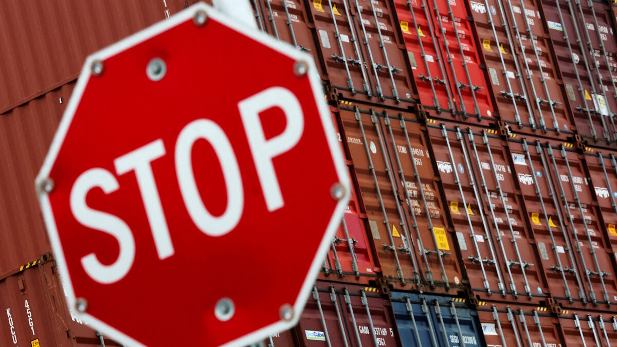 FILE PHOTO: A stop sign is pictured in front of shipping containers at the Port of Long Beach in Long Beach, California, U.S., July 11, 2025.