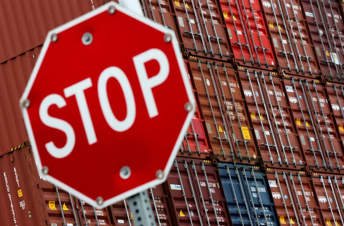 FILE PHOTO: A stop sign is pictured in front of shipping containers at the Port of Long Beach in Long Beach, California, U.S., July 11, 2025.