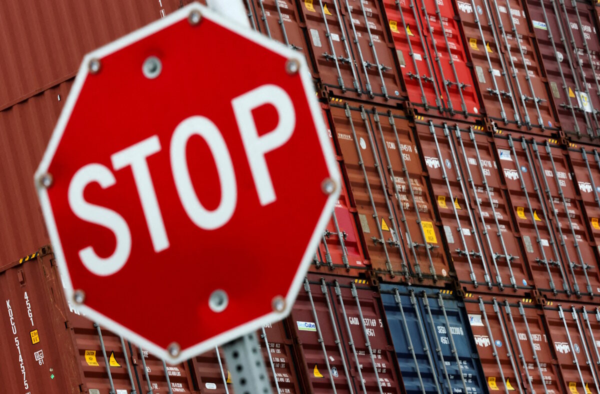 FILE PHOTO: A stop sign is pictured in front of shipping containers at the Port of Long Beach in Long Beach, California, U.S., July 11, 2025.