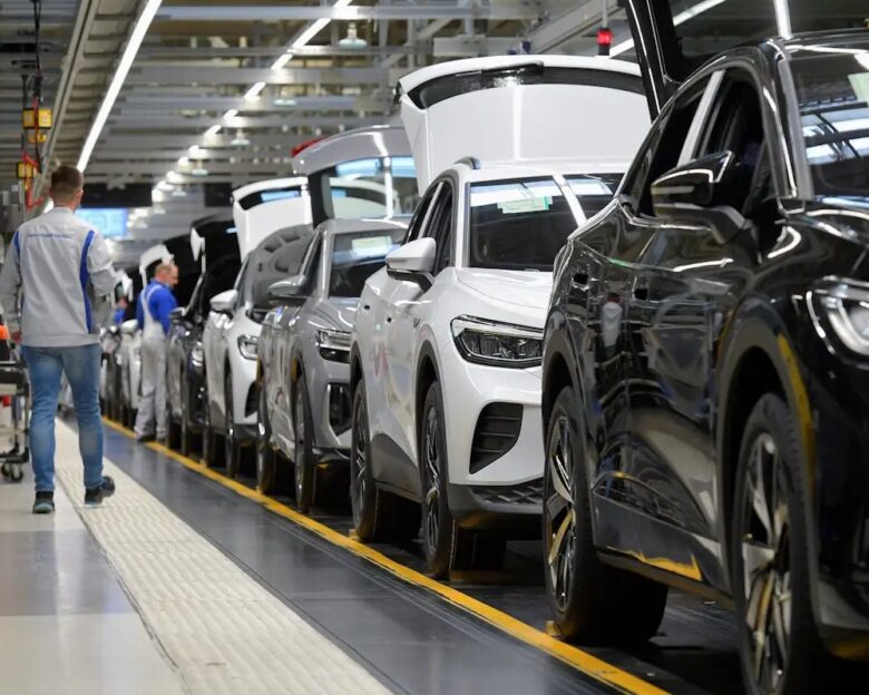 FILE PHOTO: Technicians work at the production line for electric car models of the Volkswagen Group in Zwickau, Germany, April 26, 2022. REUTERS/Matthias Rietschel/File Photo