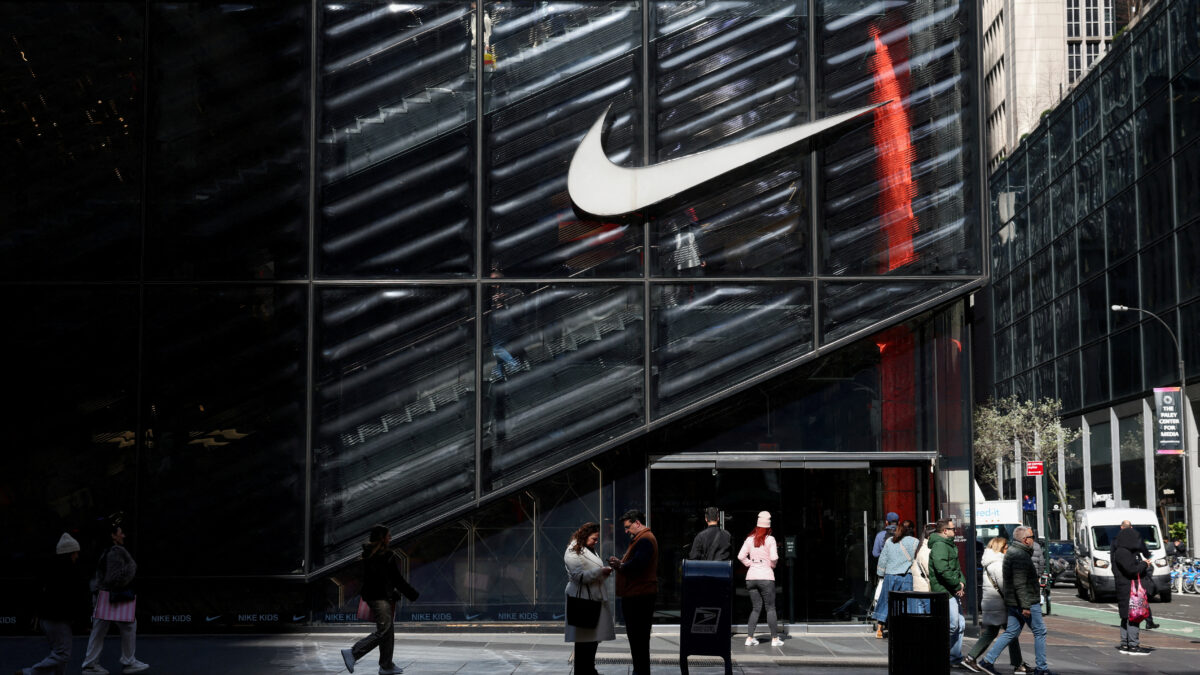 FILE PHOTO: People walk past a Nike store in New York City, U.S., April 2, 2025. REUTERS / Kylie Cooper