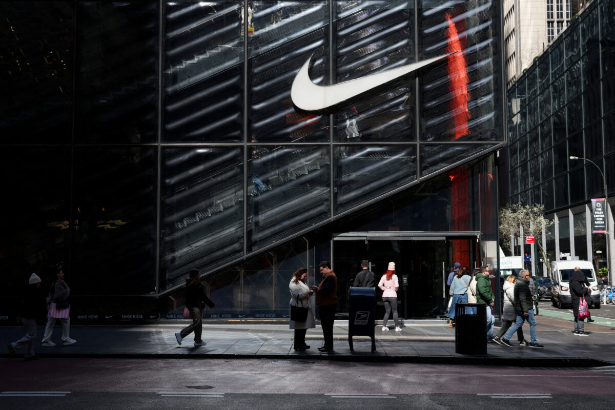 FILE PHOTO: People walk past a Nike store in New York City, U.S., April 2, 2025. REUTERS / Kylie Cooper