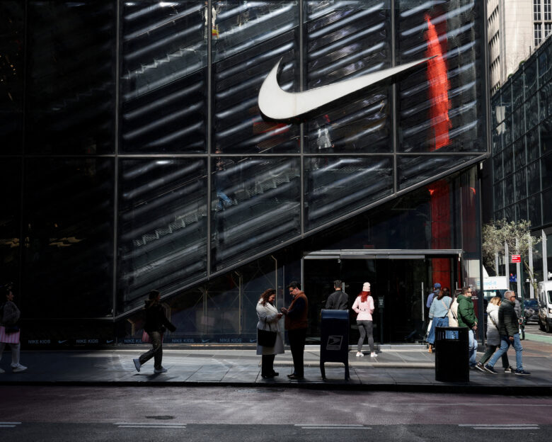 FILE PHOTO: People walk past a Nike store in New York City, U.S., April 2, 2025. REUTERS / Kylie Cooper