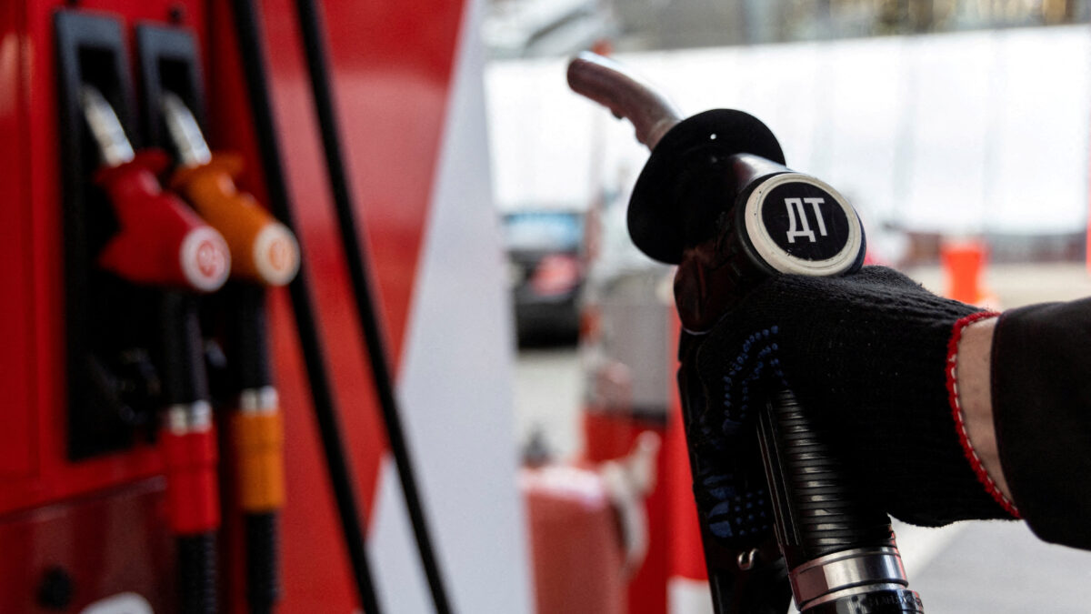 FILE PHOTO: An employee holds a diesel fuel pump nozzle at a petrol station of Neftmagistral company in Moscow, Russia, September 8, 2023.