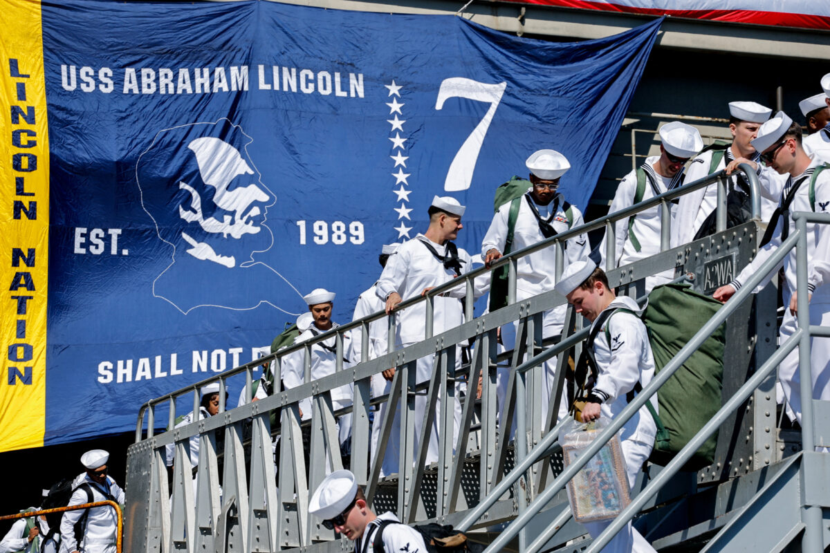 Members of the US Navy disembark the Nimitz-class aircraft carrier USS Abraham Lincoln after it returned home following an extended deployment in the Middle East at Naval Base Coronado in San Diego, California, U.S., October 8, 2026. REUTERS