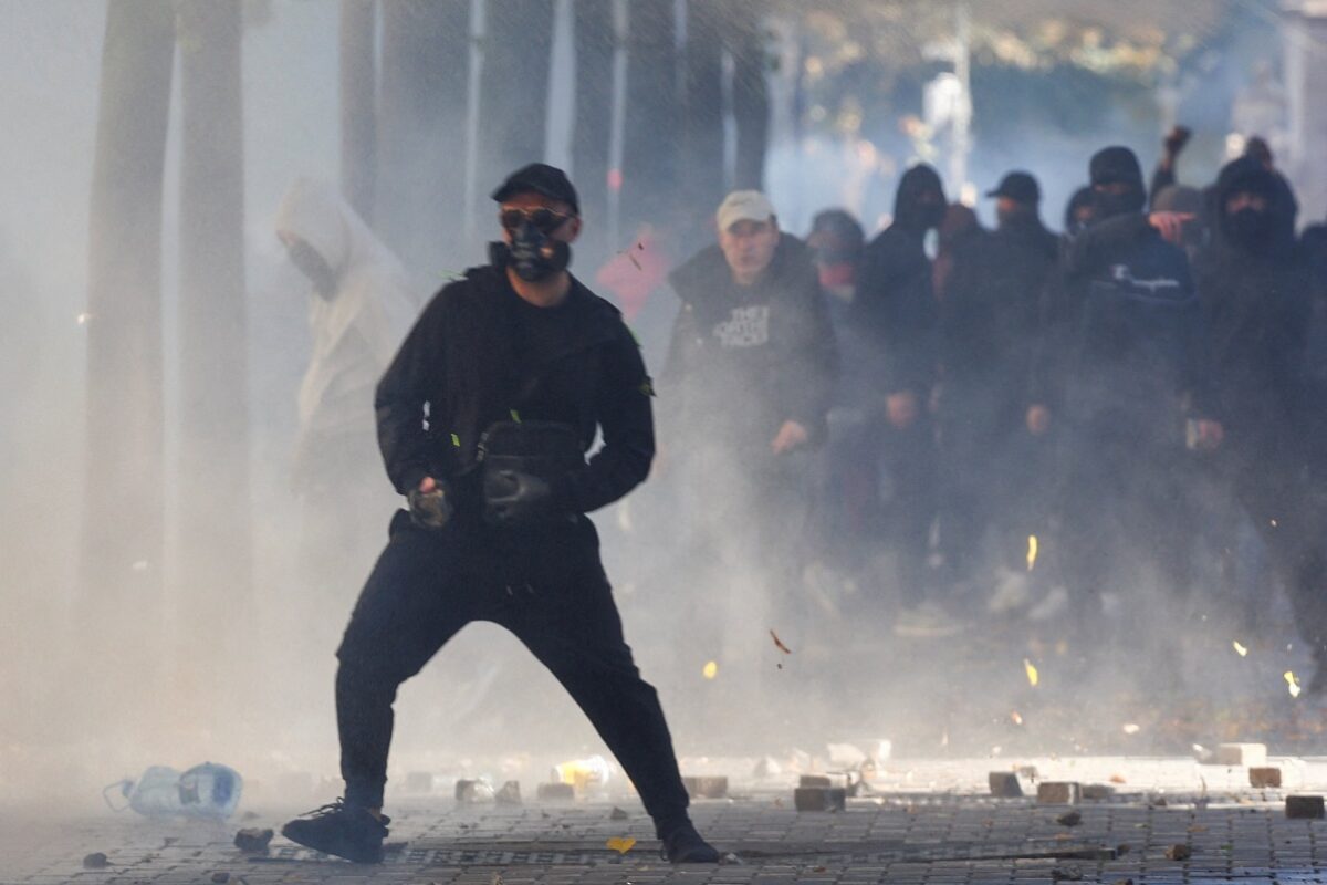 A protester reacts, as plumes of smoke linger in the air, amid an anti-government protest by students in Tirana, Albania, October 17, 2026. REUTERS