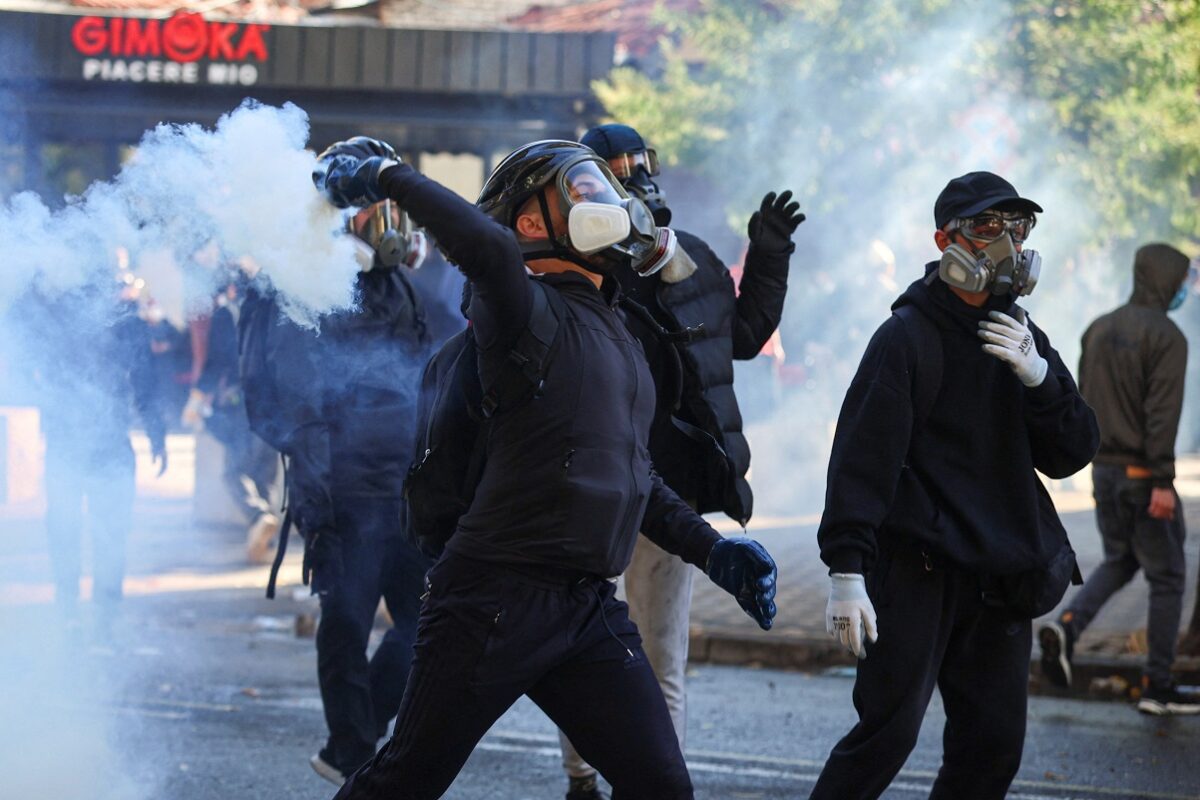 A demonstrators wearing a gas mask throws back a tear gas canister during an anti-government protest by students in Tirana, Albania, October 17, 2026. REUTERS