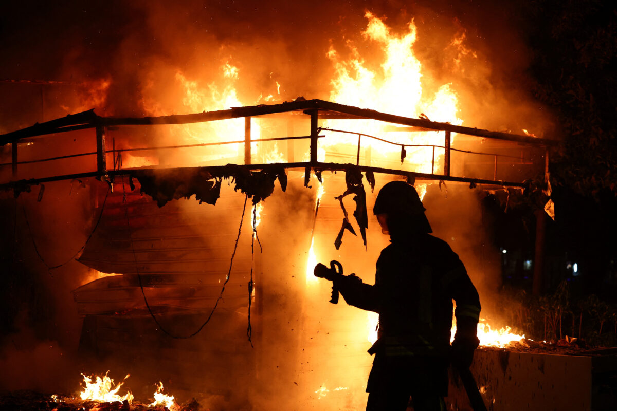 A firefighter stands in front of a fire during clashes between police and demonstrators amid an anti-government protest by students in Tirana, Albania, October 15, 2026. REUTERS