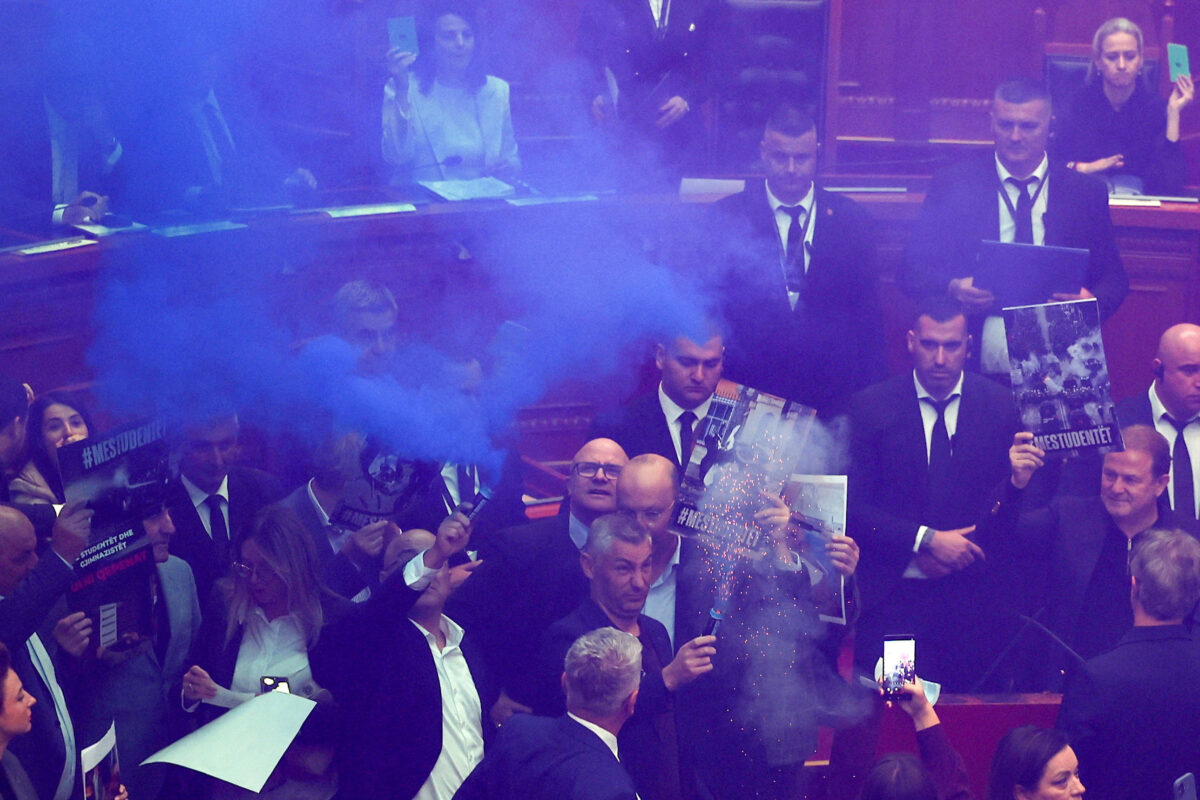 A person holds a flare as members of parliament from the Democratic Party, Albania's biggest opposition party, protest against the government inside the parliament in Tirana, Albania, October 29, 2026. REUTERS