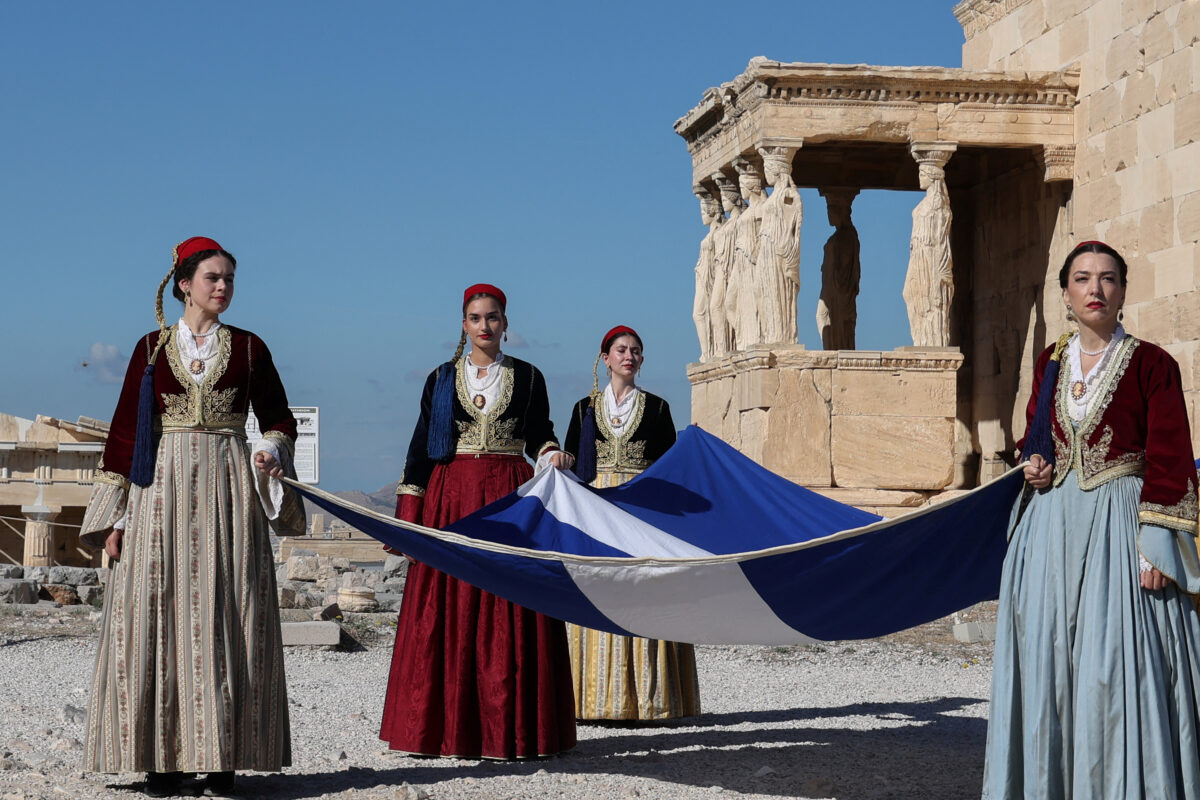 Presidential Guards stand in front of the Parthenon temple during a ceremony marking the 82nd anniversary of the liberation of Athens from Nazi occupation, atop the Acropolis hill in Athens, Greece, October 12, 2026. REUTERS/Louisa Gouliamaki