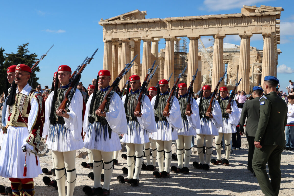 Presidential Guards stand in front of the Parthenon temple during a ceremony marking the 82nd anniversary of the liberation of Athens from Nazi occupation, atop the Acropolis hill in Athens, Greece, October 12, 2026. REUTERS/Louisa Gouliamaki