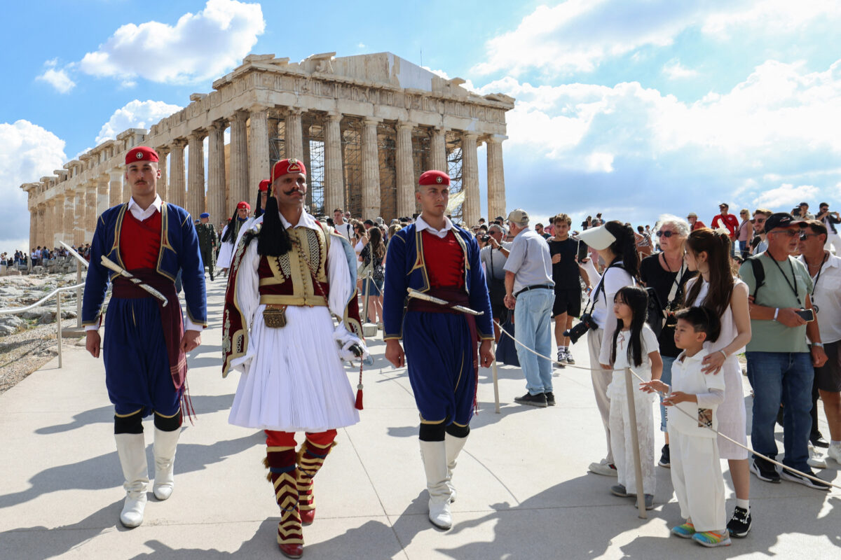 Presidential Guards stand in front of the Parthenon temple during a ceremony marking the 82nd anniversary of the liberation of Athens from Nazi occupation, atop the Acropolis hill in Athens, Greece, October 12, 2026. REUTERS/Louisa Gouliamaki