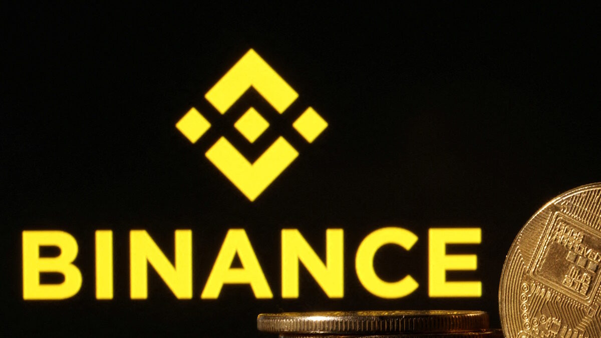 FILE PHOTO: Representations of cryptocurrencies are seen in front of displayed Binance logo in this illustration taken November 10, 2022.