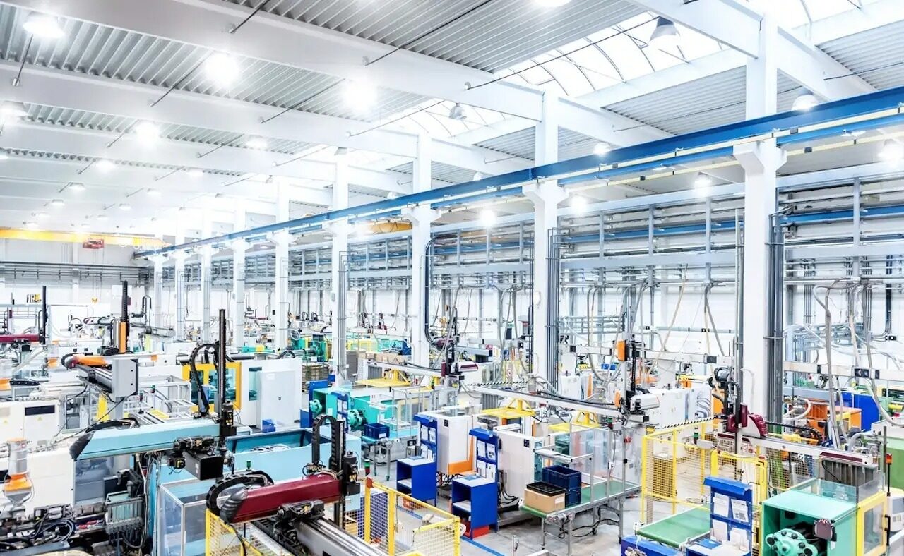 Horizontal color image of large group of modern machines in new factory.