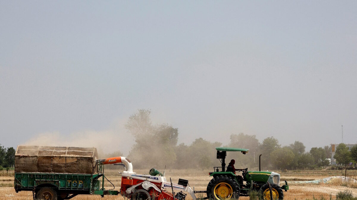 FILE PHOTO: A farmer removes stubble with the help of a machine in a wheat field in Mathura, in the northern state of Uttar Pradesh, India, April 25, 2024.