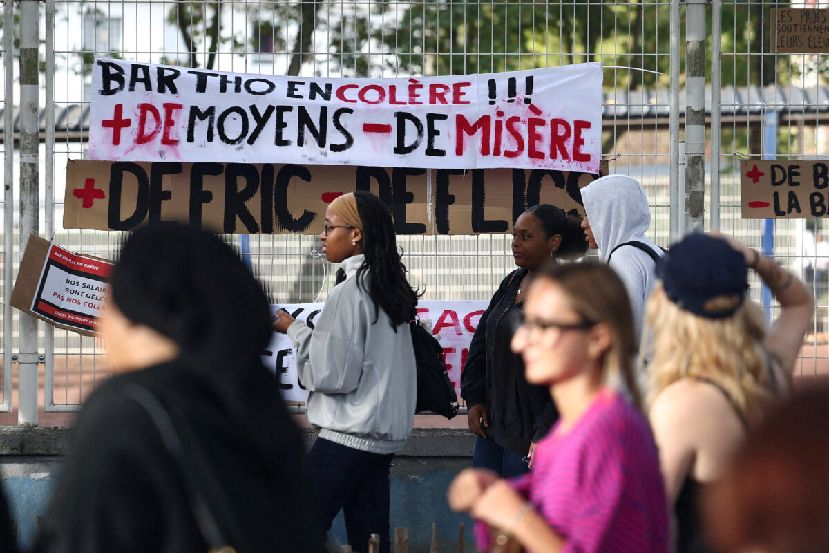 FILE PHOTO: French high school and university students gather outside the Lycee Frederic Bartholdi high-school during a protest to demand the hiring of substitute teachers, increased resources and better learning conditions, and to support the ongoing high-school student movement in the Seine-Saint-Denis department, in Saint-Denis near Paris, France, October 1, 2026. The banner reads "Angry Bartholdi high school, more resources and less misery". REUTERS
