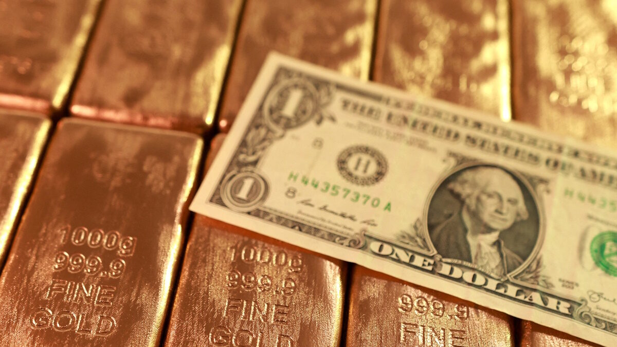 FILE PHOTO: Gold imitations and a U.S. dollar banknote are seen in this illustration picture taken February 20, 2026.