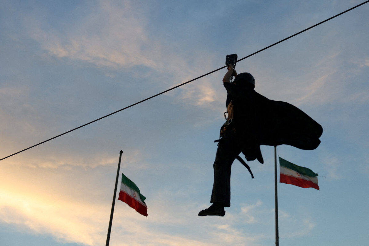 An Iranian woman volunteer uses a zipline as she receives military training at a military training center for ordinary citizens at Imam Hussein Square in central Tehran, Iran, October 4, 2026. Majid Asgaripour