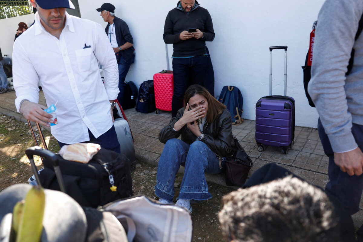 A survivor reacts while waiting to board a bus outside the municipal center where they have been taken, following the collision of two high-speed trains between the towns of Mora and Orgaz, in Urda, Spain, October 28, 2026. REUTERS