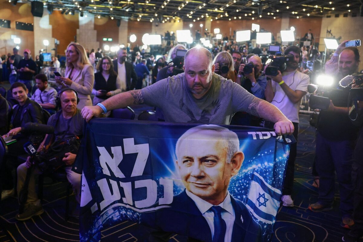 A supporter holds a banner depicting Israeli Prime Minister and Likud party leader Benjamin Netanyahu during Israel's national election, at Likud's election headquarters in Jerusalem, October 27, 2026. REUTERS